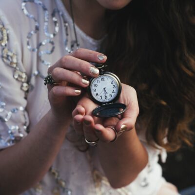 woman holding a pocketwatch