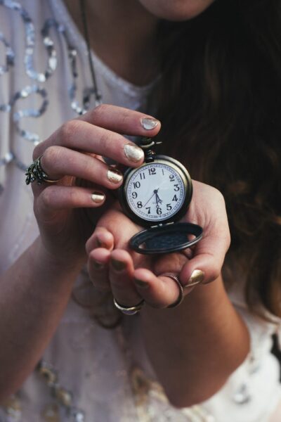 woman holding a pocketwatch